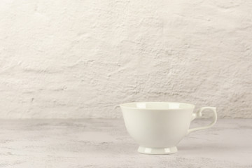 white classic coffee cup on white desk in the kitchen room.