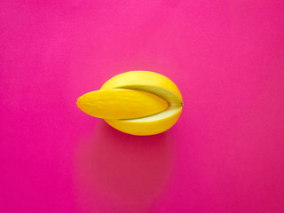 Yellow Melon Fruit isolated in plastic pink background viewed from above - flatlay look - Image