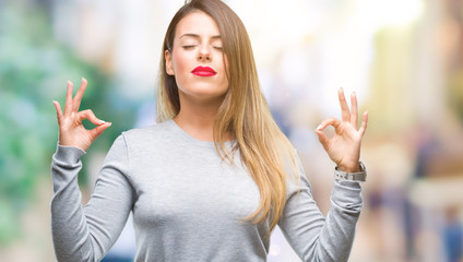 Young beautiful worker business woman over isolated background relax and smiling with eyes closed doing meditation gesture with fingers. Yoga concept.