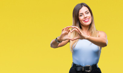 Young beautiful elegant business woman over isolated background smiling in love showing heart symbol and shape with hands. Romantic concept.