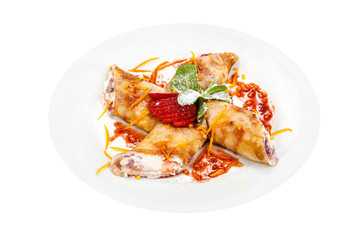 Wrapped pancakes with cottage cheese, jam and strawberries on a white plate, on white background