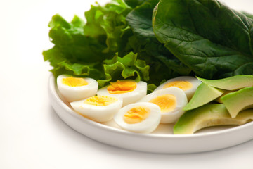 boiled quail eggs, spinach, lettuce, avocado. Copy space