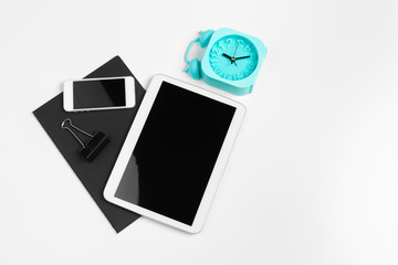 smartphone, tablet, notebook  pen on the background of a wooden table