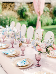 Table setting at a luxury wedding reception. Outdoor wedding