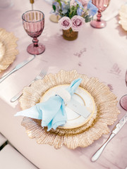 Table setting at a luxury wedding reception. Outdoor wedding