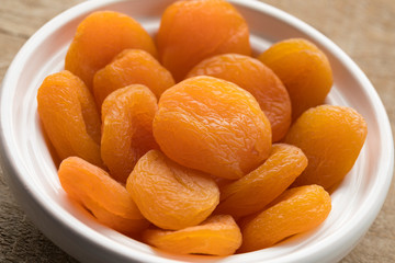 White bowl with dried orange apricot fruit