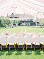 Table setting at a luxury wedding reception. Outdoor wedding