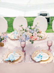 Table setting at a luxury wedding reception. Outdoor wedding