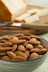 Bowl with peeled almonds close up as a snack