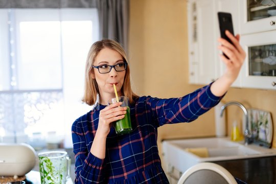 Young happy pregnant woman taking selfie photo with phone