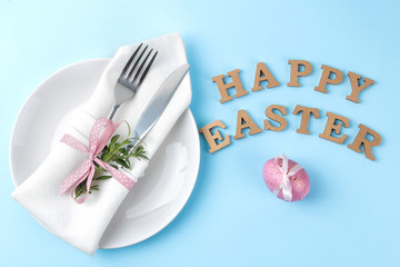 Easter. Pink Easter eggs and a knife with a fork on a trendy blue background. Easter table setting. Happy easter. holidays. top view.