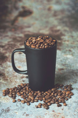 Cup of coffee, cup stuffed with coffee beans