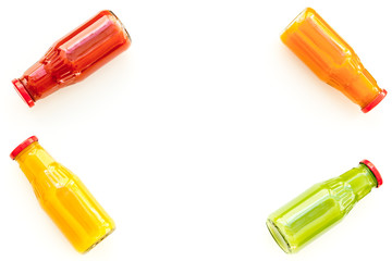 bottles with fresh carrot, tomato, apple, cucumber, lemon, pomegranate juices on white background top view copyspace