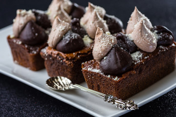 Triple Chocolate Torte on a white dish with dark background