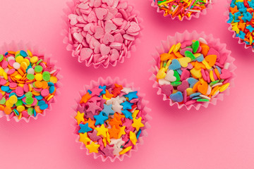 Sugar sprinkles  food background on pink cardboard