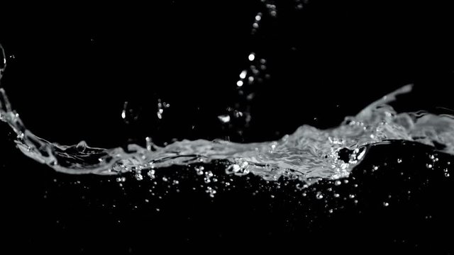 Super slow motion of splashing water isolated on black background, filmed on high speed cinematic camera, 1000 fps.