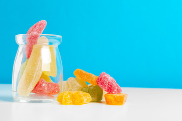 Bottles with sweet candies on table