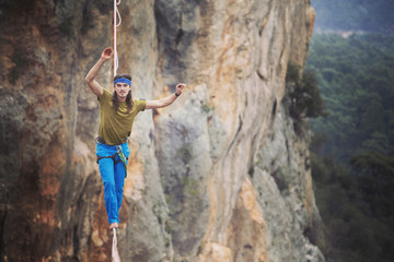 Obraz premium Man balancing on the rope concept of risk taking and challenge.