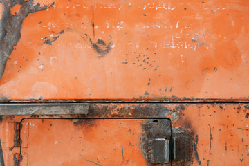 The texture of old rusty metal. Details of the broken mechanism and peeling paint.