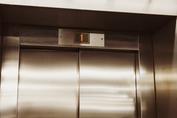 Closed door of the lift. Elevator on the first floor. - 256402343