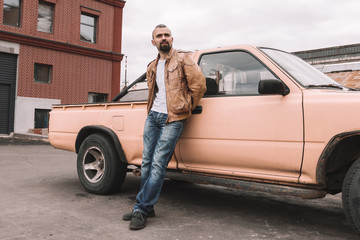 young man standing near a pickup truck . © yurolaitsalbert