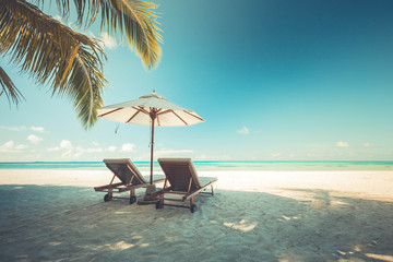Beautiful beach. Chairs on the sandy beach near the sea. Summer holiday and vacation concept. Tropical beach landscape. Exotic vacation and summer holiday concept design