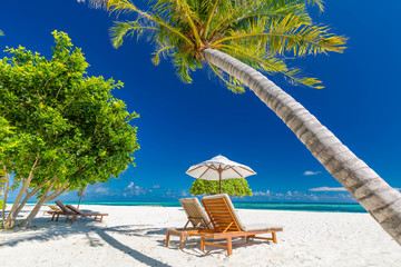 Luxury beach resort, beach loungers near the sea with white sand over sea Topical island background, summer vacation concept, holiday and tourism design. Exotic landscape, inspirational leisure banner