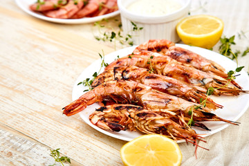 Grilled big tiger shrimps prawns on white plate