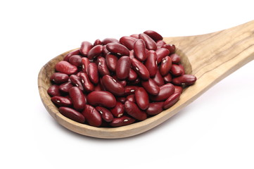 Raw red beans with wooden spoon isolated on white background