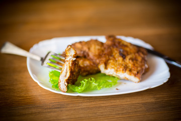 pork fillet chop fried in batter, in a plate