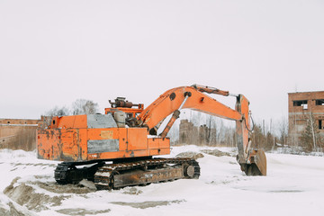 Old rusty excavator in the winter of his career. Working equipment for digging.