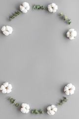 Flowers frame with fresh eucalyptus branches and cotton on grey background top view space for text