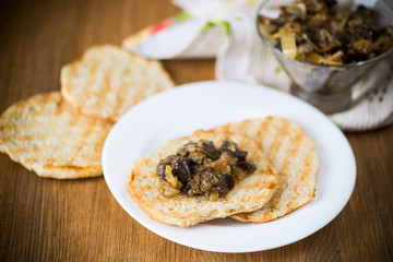 appetizer of cooked eggplant with vegetables on bread
