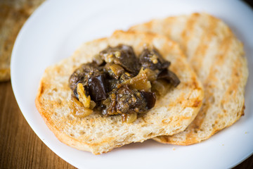 appetizer of cooked eggplant with vegetables on bread