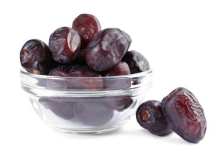 dates in glass bowl on white background