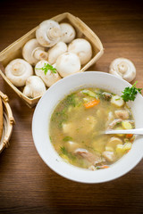 homemade rural soup with vegetables and mushrooms in a bowl