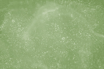 Green spring watercolor texture with abstract washes and brush strokes on the white paper background. Chaotic abstract organic design.