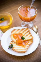 fried toast with apricot jam in a plate