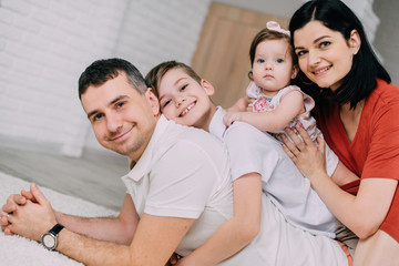Cheerful portrait of happy young family at home
