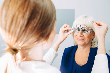 Senior woman having her eyes checked at ophthalmologist