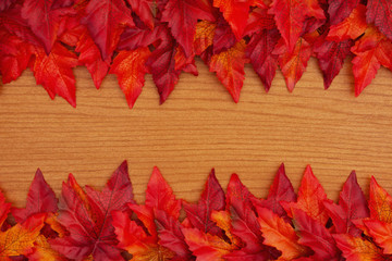 Autumn background with red and orange fall leaves on wood