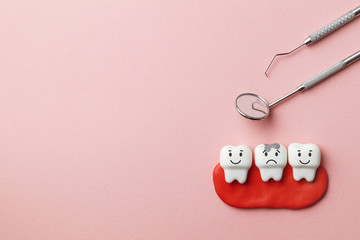 Healthy white teeth are smiling and tooth with caries is sad on pink background  and dentist tools...