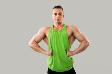handsome athletic man with muscles in a green vest