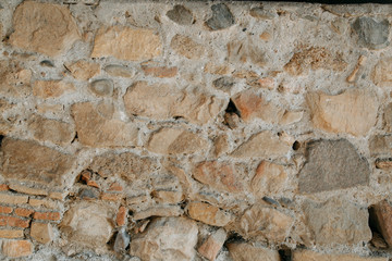Texture of old masonry walls in Georgia. Sunlight and shadows from the leaves on the bricks.