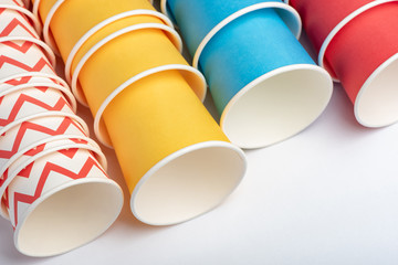 Multicolored eco paper party cups on white background