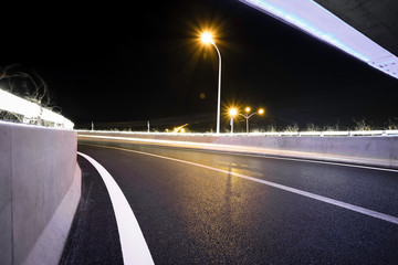 Fototapeta na wymiar Empty road floor with city viaduct bridge of neon lights night