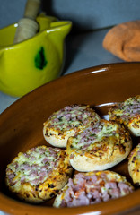 SMALL PIZZAS IN A ROLLED PLATE IN A KITCHEN TABLE