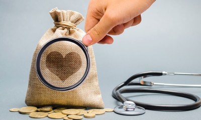 Money bag and heart image with stethoscope. The concept of medical insurance of life, family,...