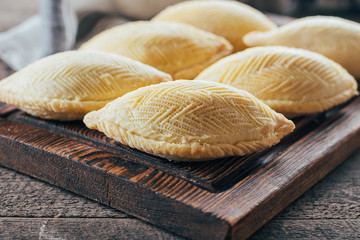 Azerbaijan national dessert. Oriental Sweet Pastry Dessert - Shekerbura on wooden board on wooden table background