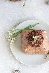 Chocolate Paskha (Pasha) with glaze. Traditional Russian orthodox Easter quark dessert. Easter food background. 